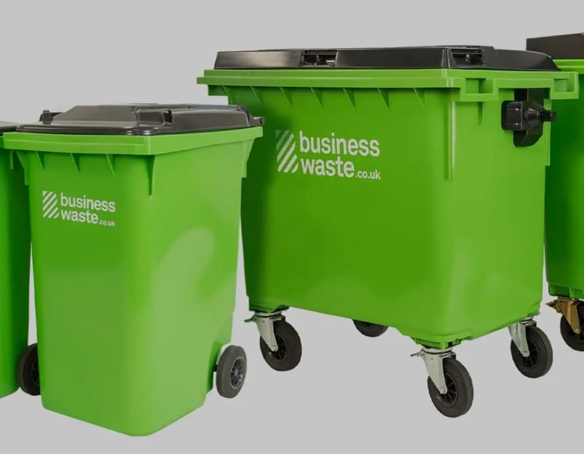 Green commercial wheelie bins used for business waste disposal and recycling