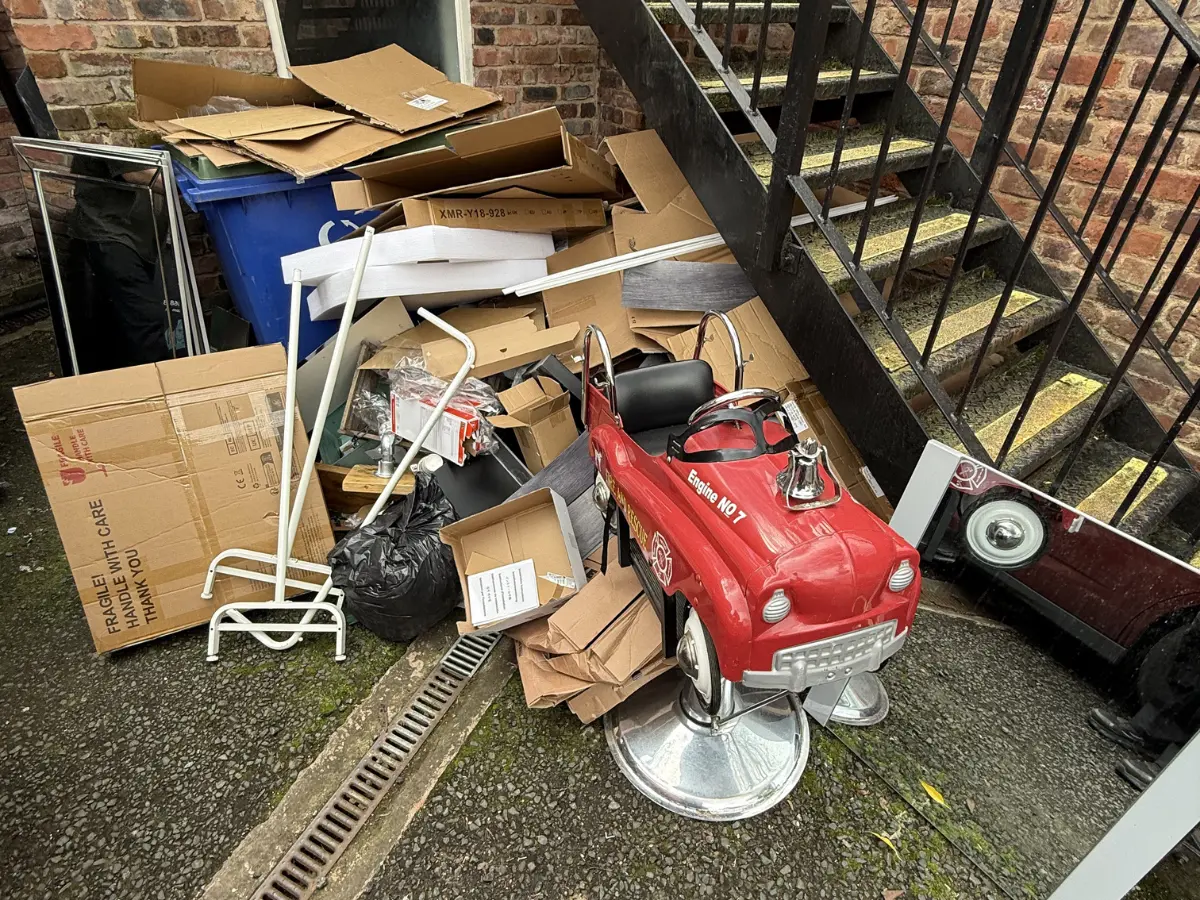 Pile of household rubbish, cardboard, furniture and bulky waste awaiting professional rubbish removal in Bolton.