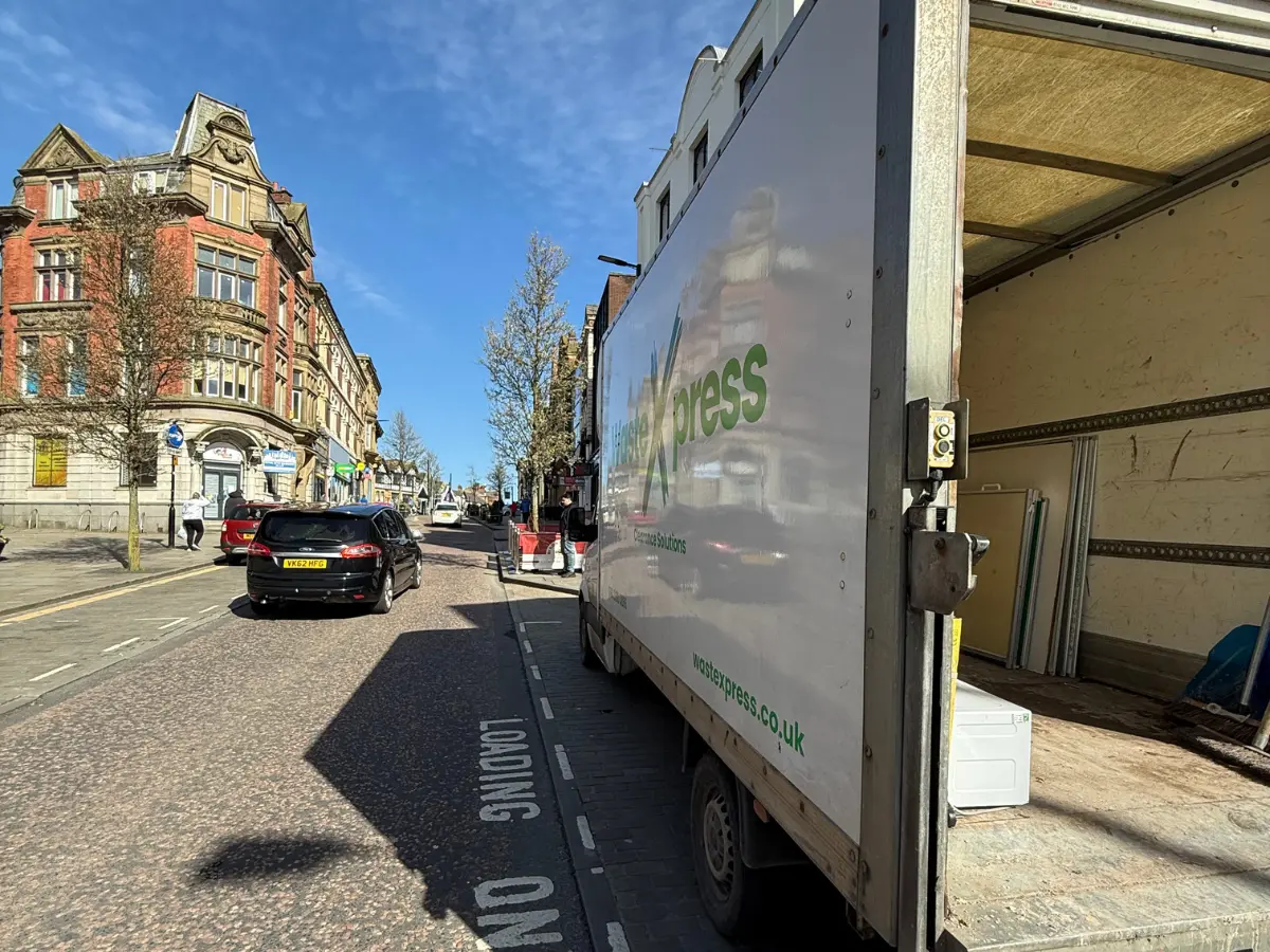 WasteXpress clearance vehicle loading office furniture and commercial waste.