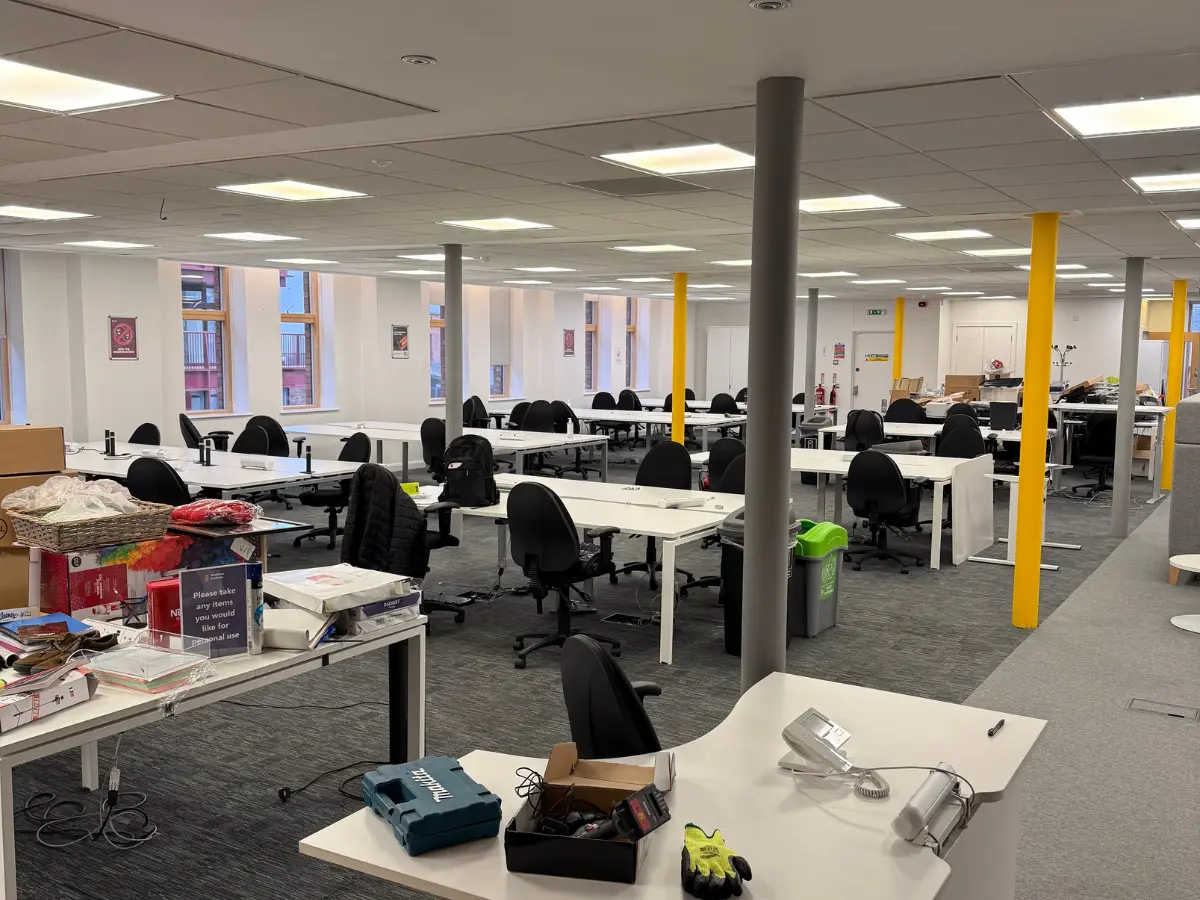 Furnished open-plan office awaiting clearance before the commercial property handover.