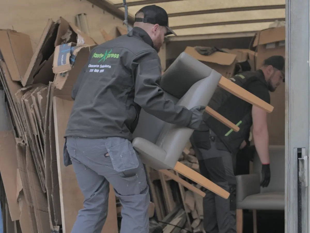 Professional house clearance team loading furniture into a van during property clearance and rubbish removal.