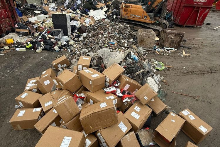 Mixed commercial waste including boxes and debris at a Manchester recycling facility