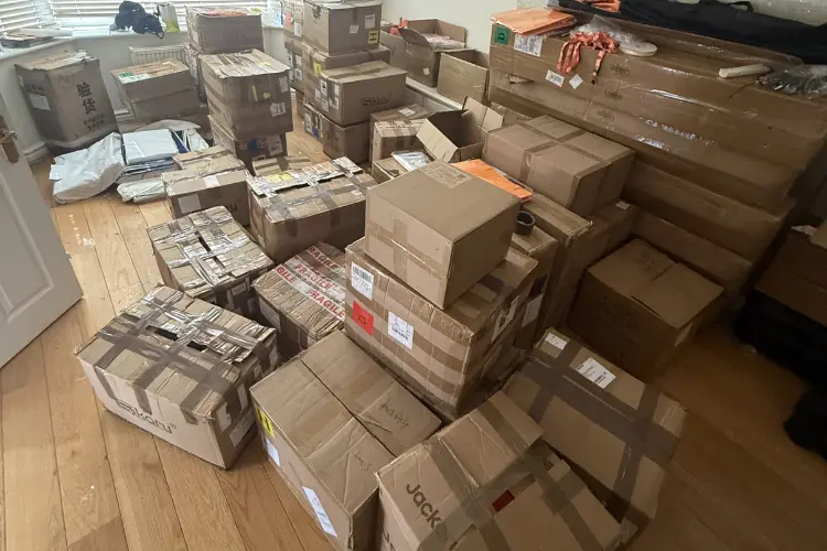 Large collection of old boxes and stored household items awaiting removal during a Manchester clearance.