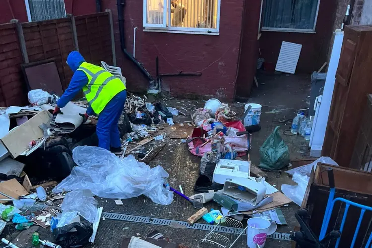 WasteXpress team member safely clearing household rubbish and clutter from a residential property in Manchester.