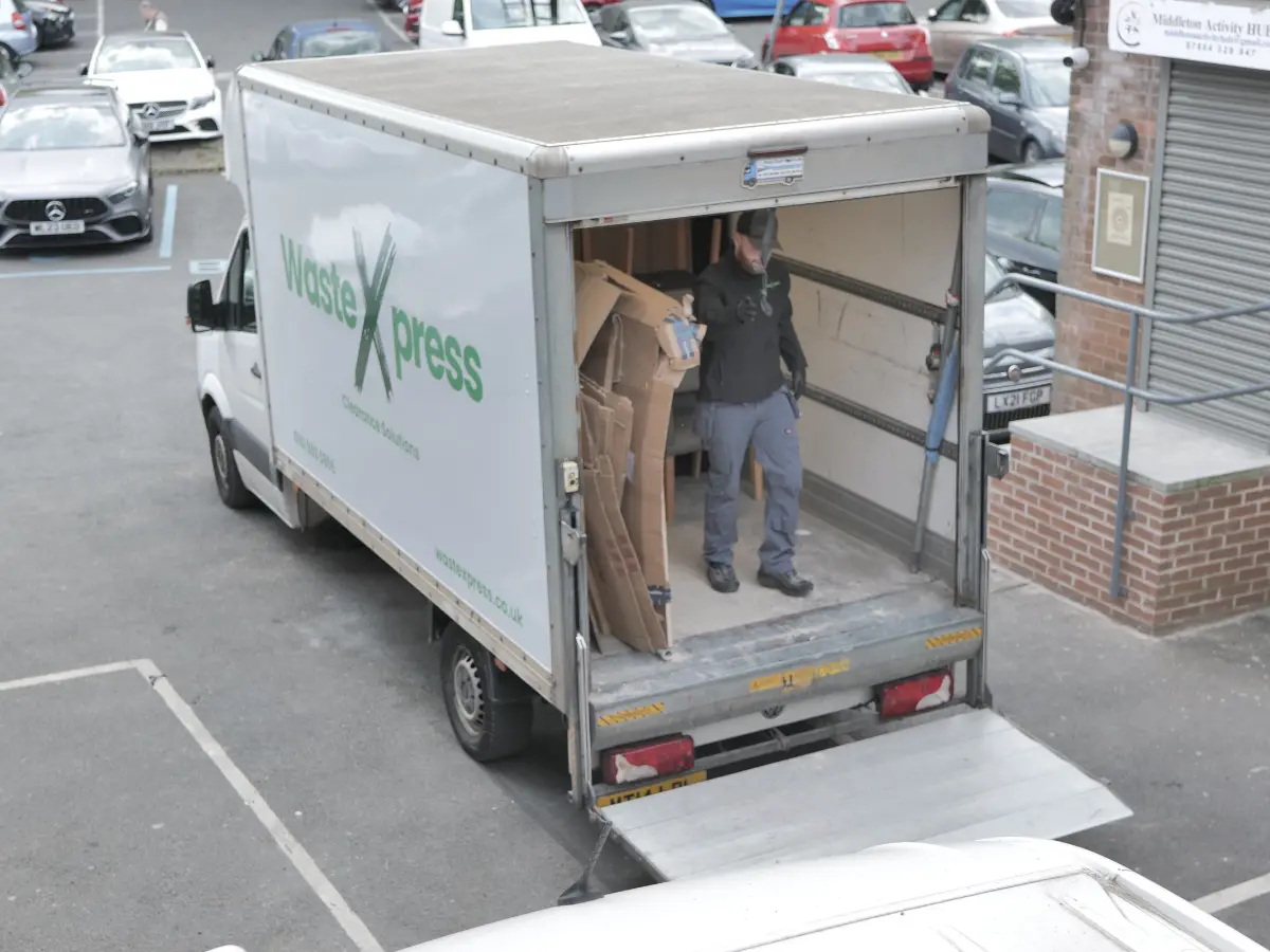 WasteXpress collection vehicle loading bulky waste and mattresses for responsible disposal and recycling.