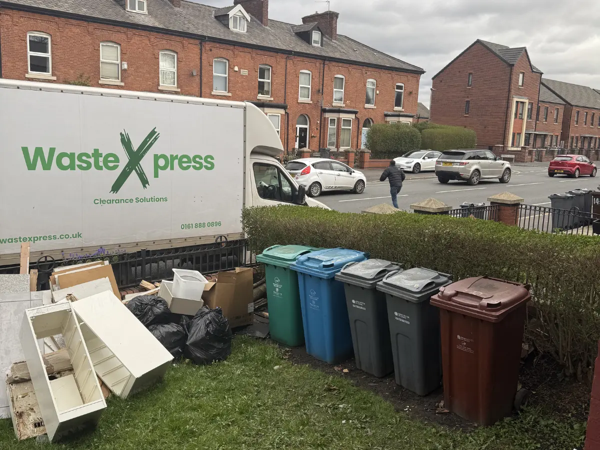 WasteXpress van parked outside a Salford home with household items ready for collection during a professional house clearance.