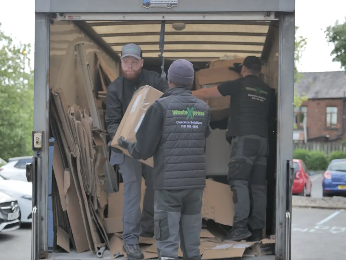 WasteXpress clearance team loading household items and cardboard boxes during a professional probate house clearance service.
