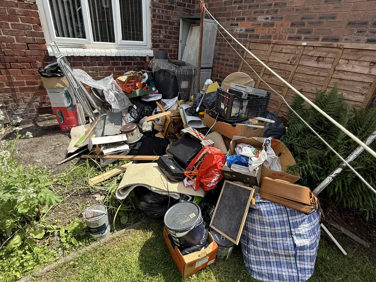 Pile of household rubbish, furniture, boxes and general waste awaiting collection during a house clearance in Salford.