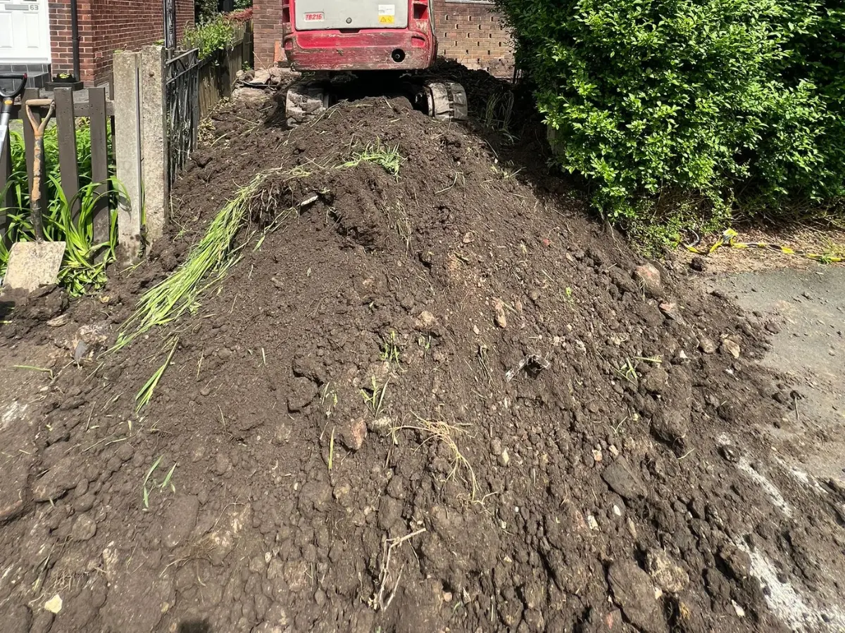 Large pile of excess soil and earth excavated during a residential garden landscaping project.