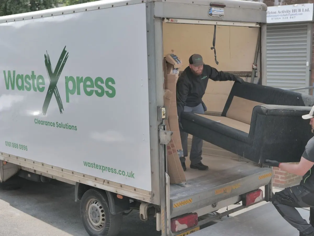 WasteXpress clearance team loading furniture into a van during same day house clearance in Manchester.