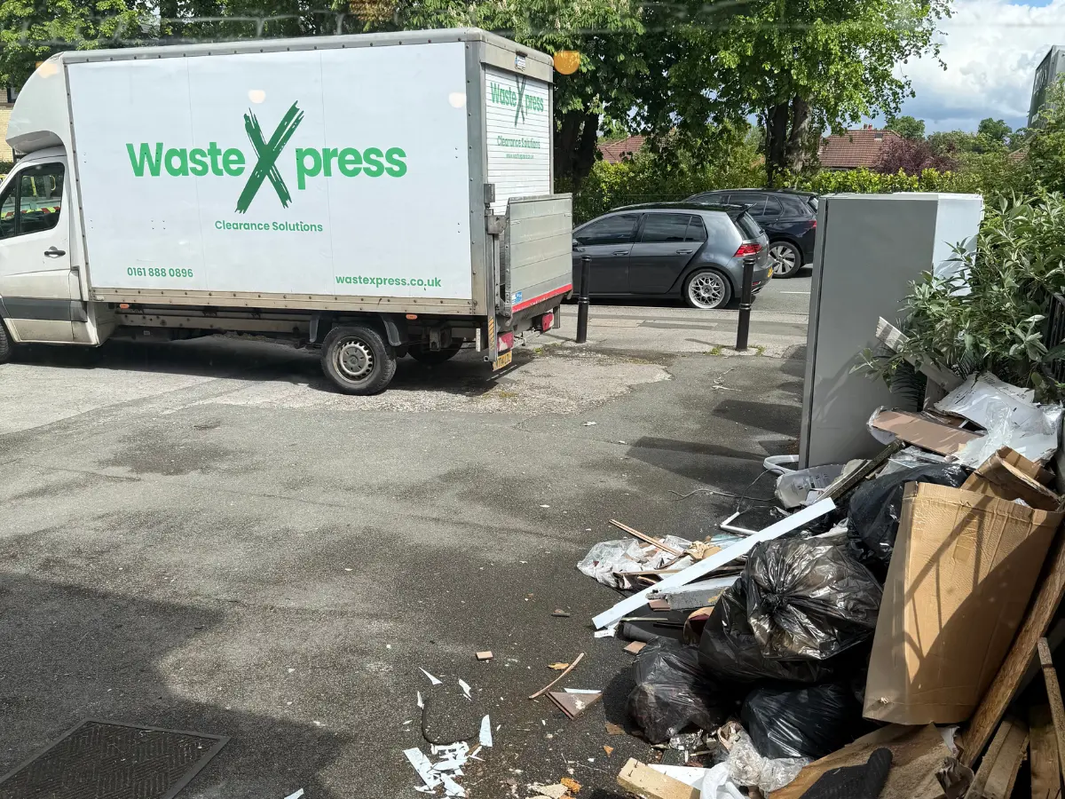WasteXpress vehicle collecting furniture and household rubbish during a rubbish removal job in Manchester.